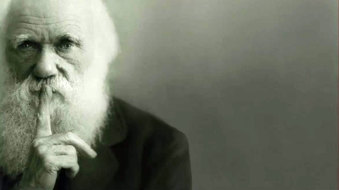 Portrait of Charles Darwin gesturing for us to be quiet