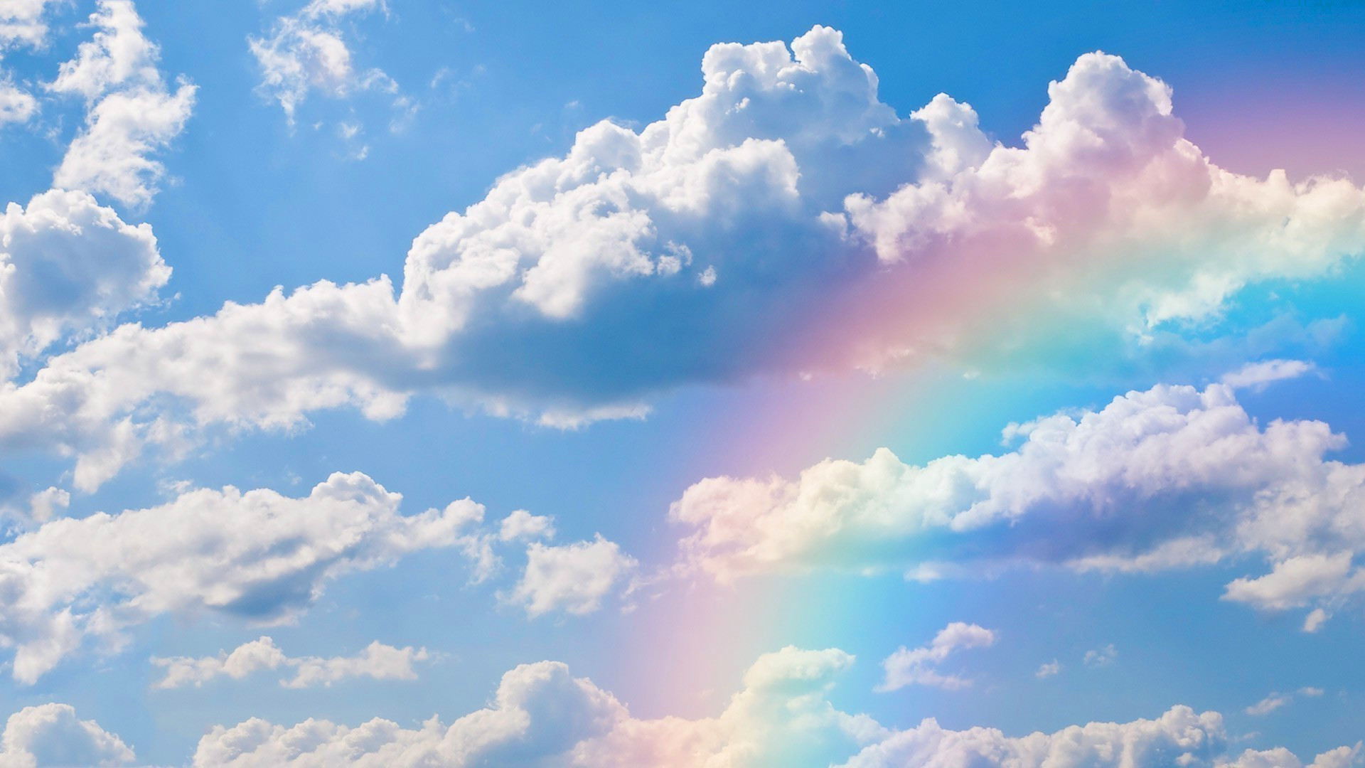 blue sky with clouds and rainbow