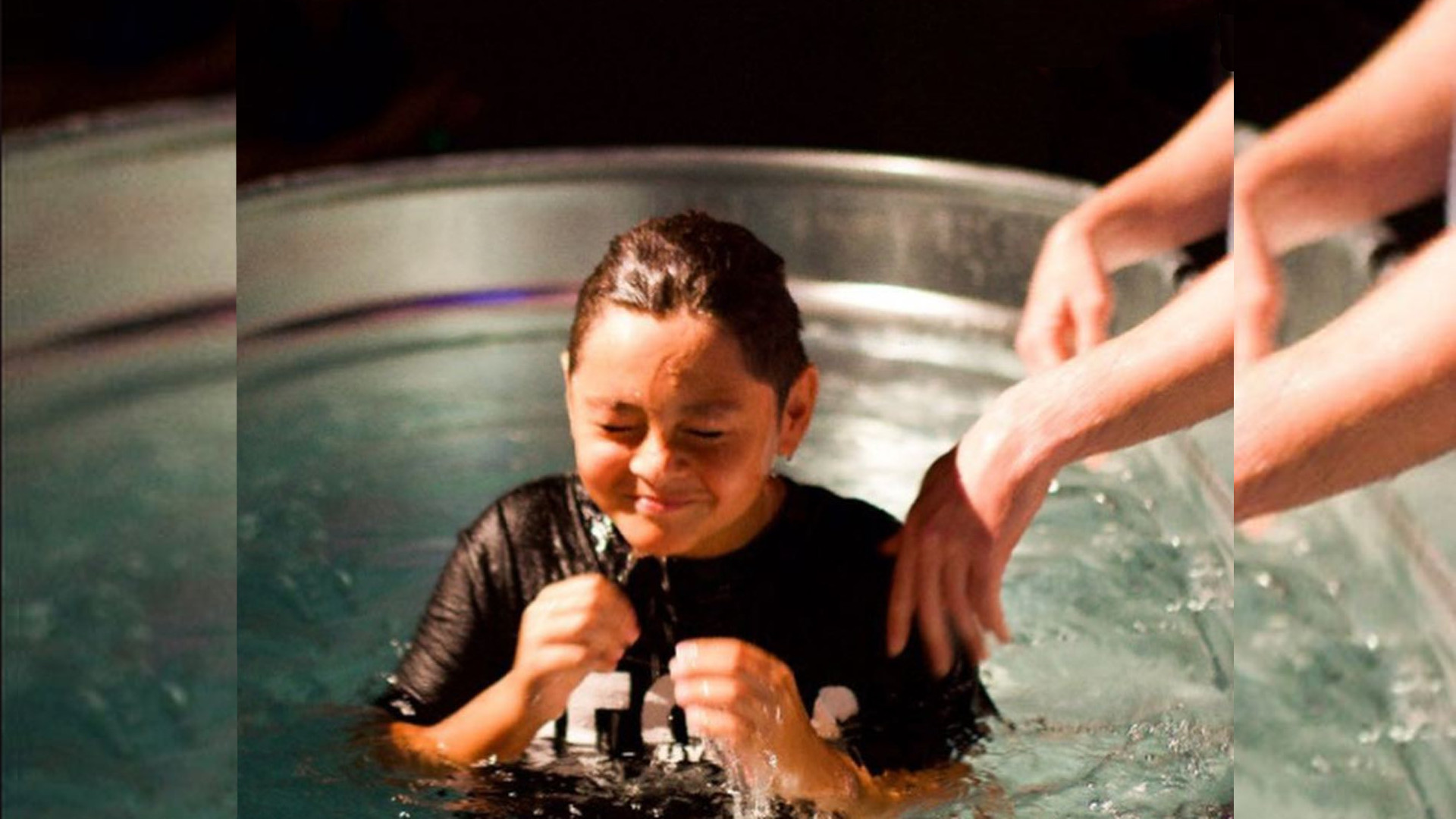 Joyful boy being baptized at Redemption Hill Church